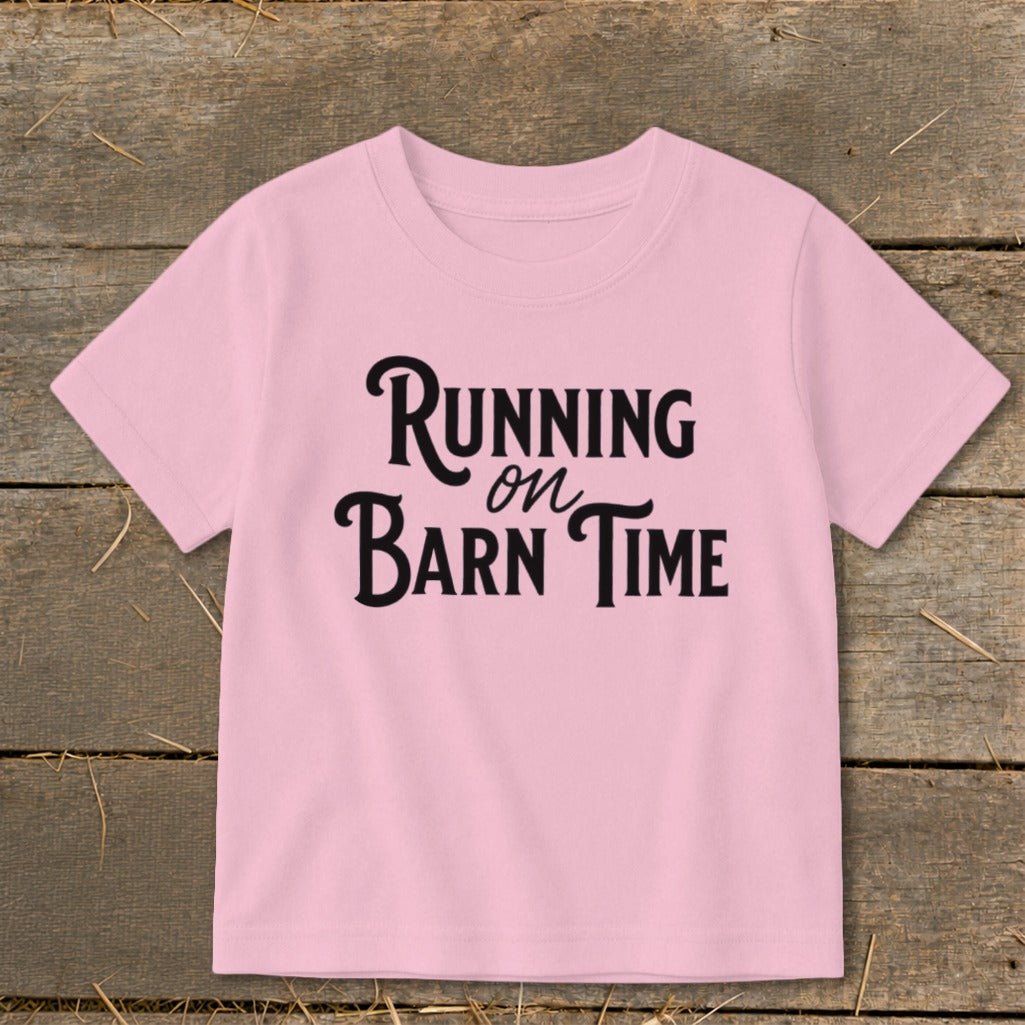 Pink t-shirt with black text that says "Running on Barn Time".