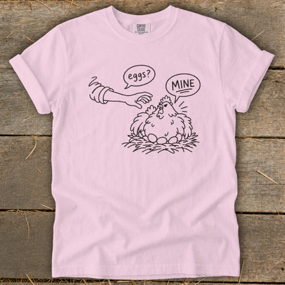 Illustration of a chicken guarding eggs, with text "eggs?" and "MINE".