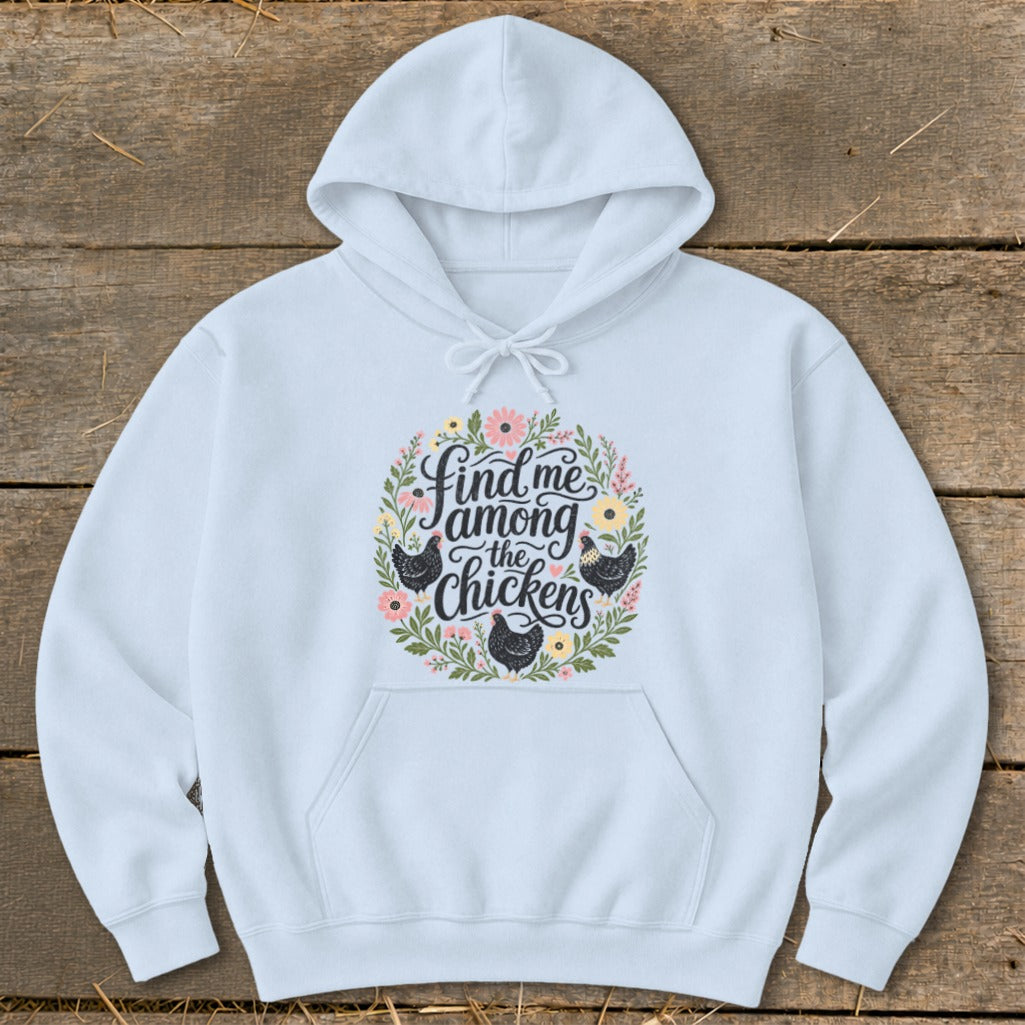Light blue hoodie with floral wreath and text "Find me among the chickens" with chickens.