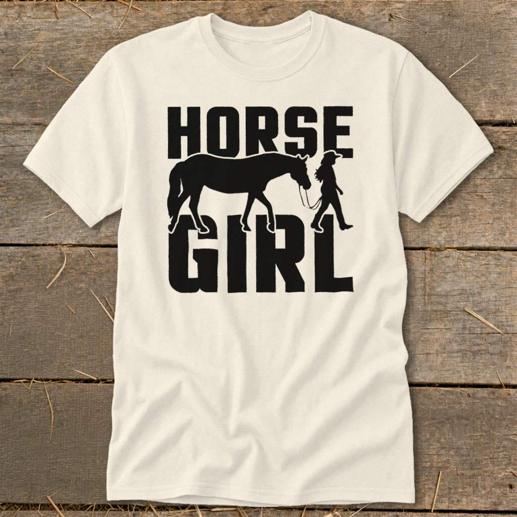 Cream t-shirt with black text and silhouette of a horse and girl.