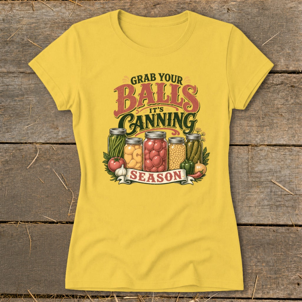 Yellow t-shirt with "Grab Your Balls It's Canning Season" text and jars of preserved food.