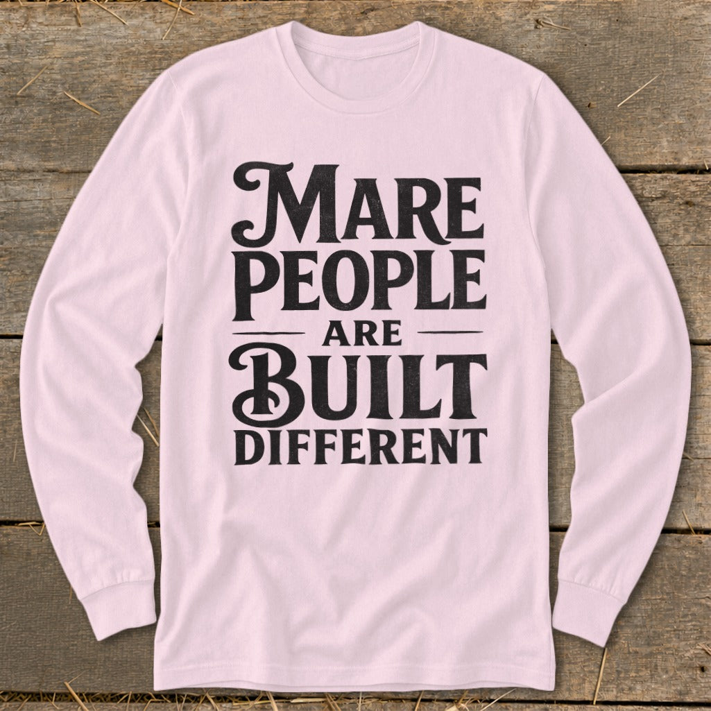 Pink long-sleeve shirt with "Mare People Are Built Different" text in black.