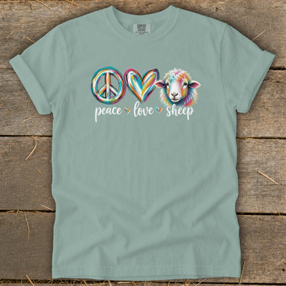 Peace love sheep graphic with colorful peace sign, heart, and sheep on a light blue t-shirt.