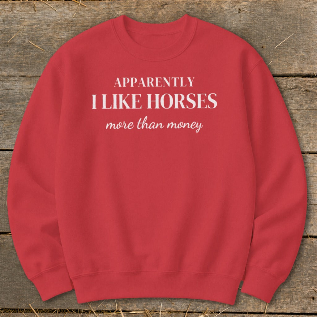 Red sweatshirt with white text: "APPARENTLY I LIKE HORSES more than money".