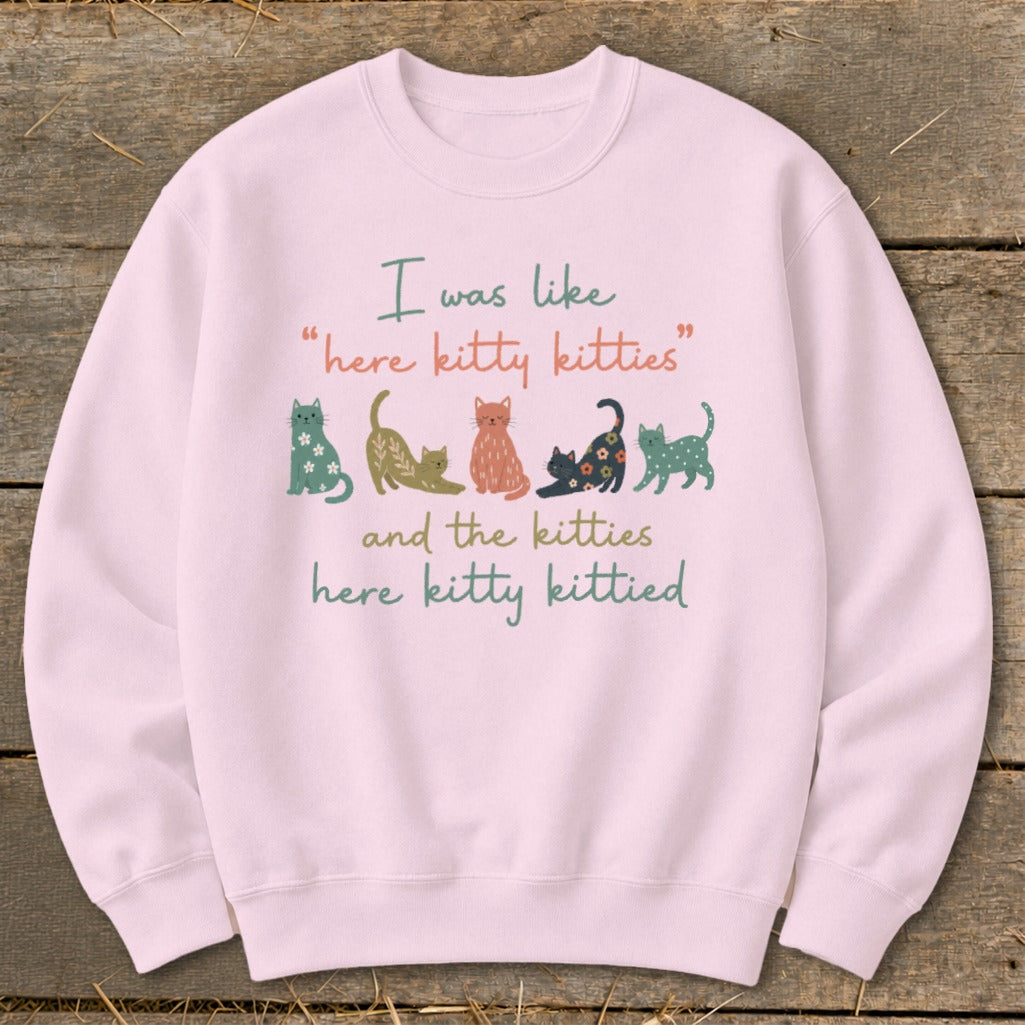 Pink sweatshirt with illustrated cats and text "I was like 'here kitty kitties' and the kitties here kitty kittied".