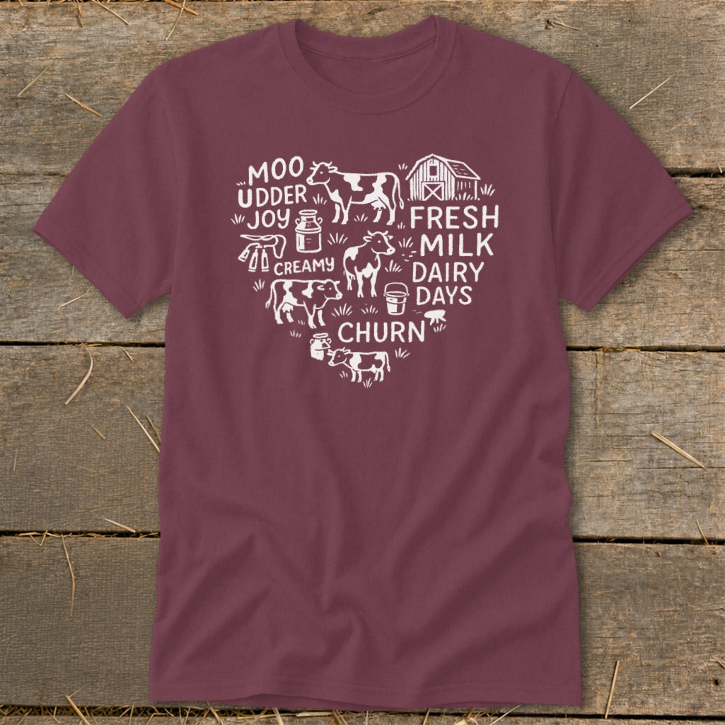 Maroon t-shirt with white heart-shaped farm graphic: cows, barn, milk jugs, and text.