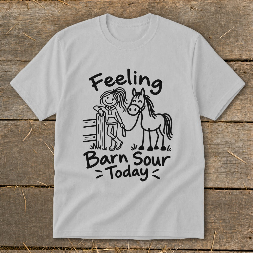 White t-shirt with black graphic of a girl leaning on a fence next to a horse, text "Feeling Barn Sour Today".