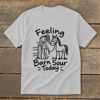 White t-shirt with black graphic of a girl leaning on a fence next to a horse, text "Feeling Barn Sour Today".