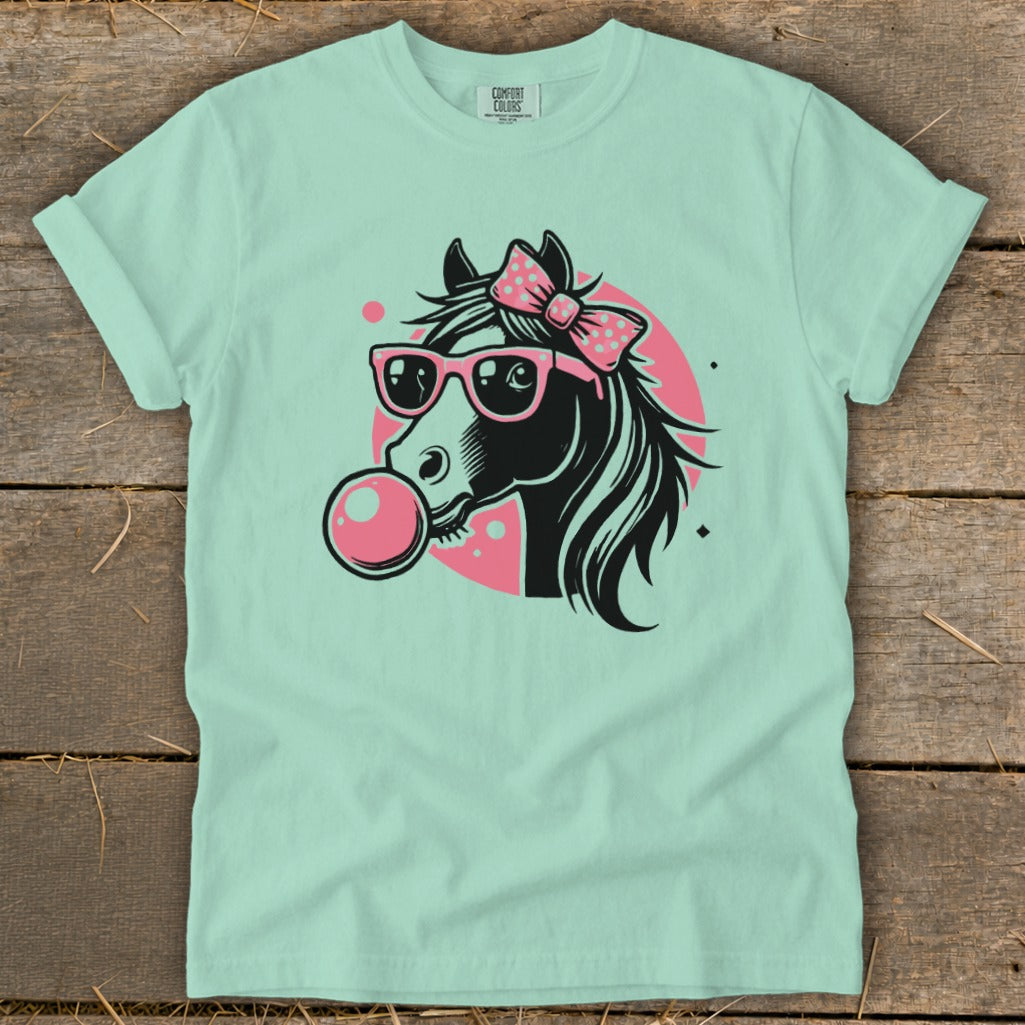 Horse with sunglasses and bow blowing bubblegum on a mint t-shirt.