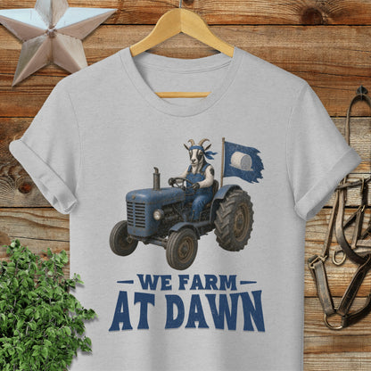 Blue tractor with a goat driver and "We Farm At Dawn" text.