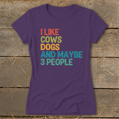 Purple t-shirt with text "I like cows dogs and maybe 3 people".