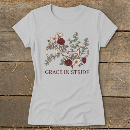 Light gray t-shirt with horse bit and floral graphic, text "GRACE IN STRIDE".