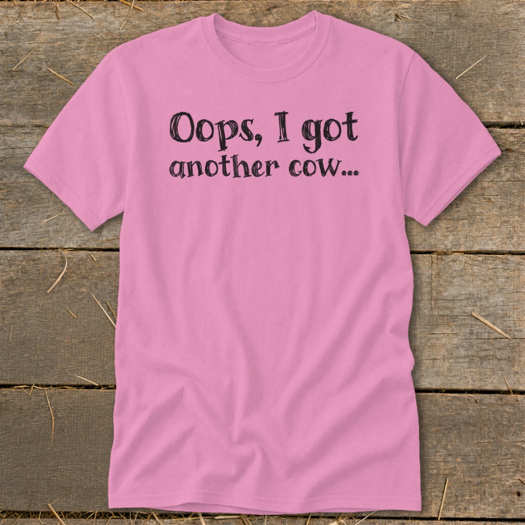 Pink t-shirt with black text that reads "Oops, I got another cow..."