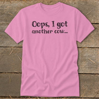 Pink t-shirt with black text that reads "Oops, I got another cow..."