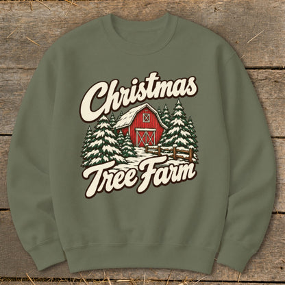 Christmas Tree Farm graphic on a green sweatshirt with barn and snow-covered trees.
