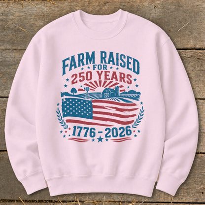 Pink sweatshirt with "Farm Raised for 250 Years 1776-2026" and farm landscape.