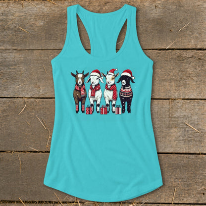 Four festive goats in Santa hats and scarves stand near presents on a teal tank top.