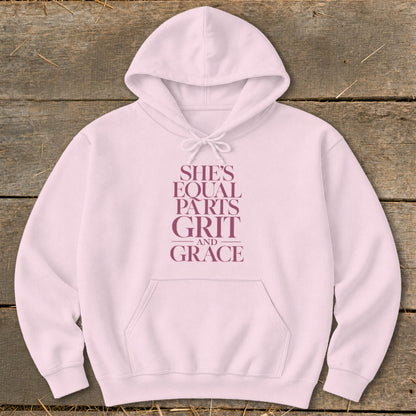 Pink hoodie with text "She's equal parts grit and grace".