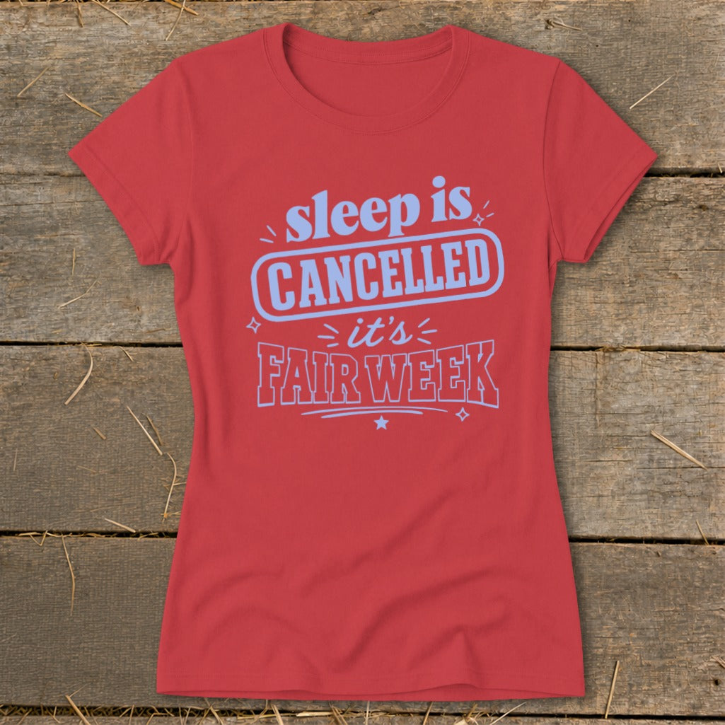 Red t-shirt with "sleep is CANCELLED it's FAIR WEEK" graphic.