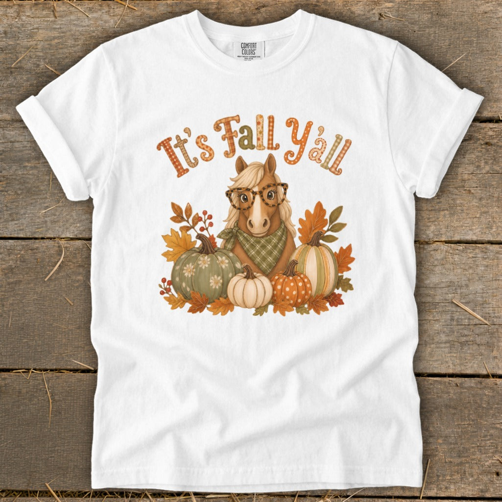 White t-shirt with a horse wearing glasses, surrounded by pumpkins and fall leaves, and text "It's Fall Y'all."