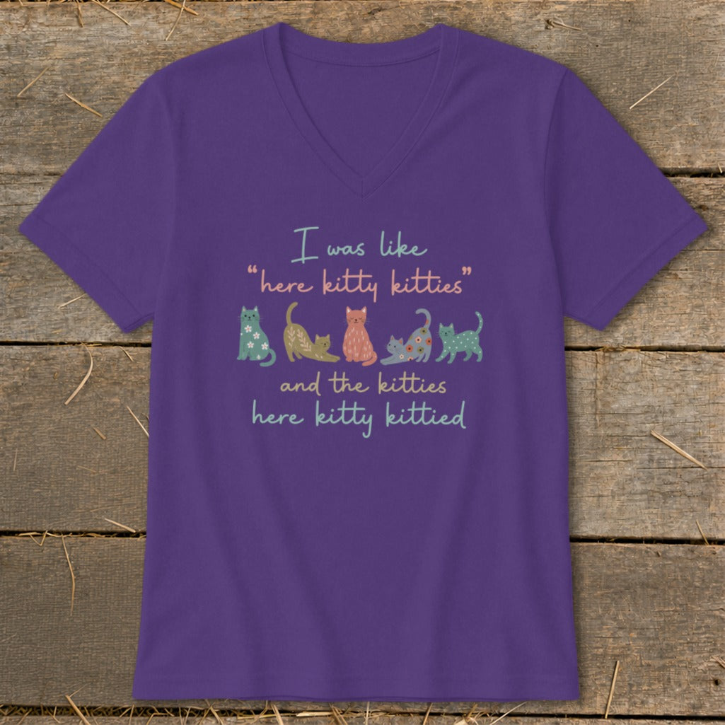Purple t-shirt with text "I was like 'here kitty kitties' and the kitties here kitty kittied" and cartoon cats.