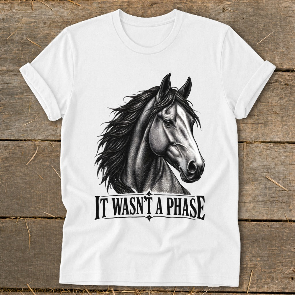 White t-shirt with a black and white drawing of a horse's head and "IT WASN'T A PHASE".