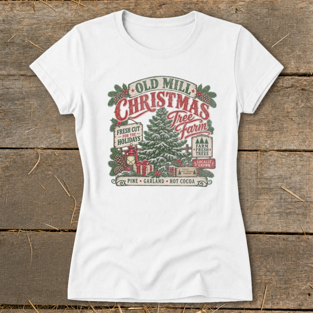White t-shirt with "Old Mill Christmas Tree Farm" graphic featuring a tree, gifts, and festive text.