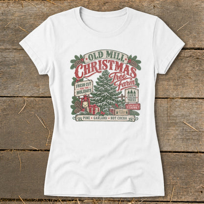 White t-shirt with "Old Mill Christmas Tree Farm" graphic featuring a tree, gifts, and festive text.