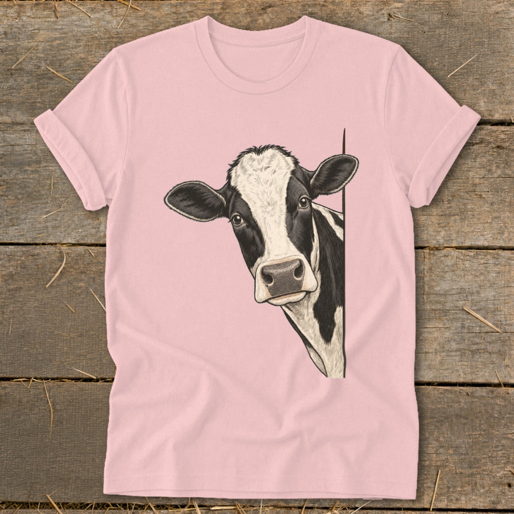 Pink t-shirt with a black and white cow peeking from the side.