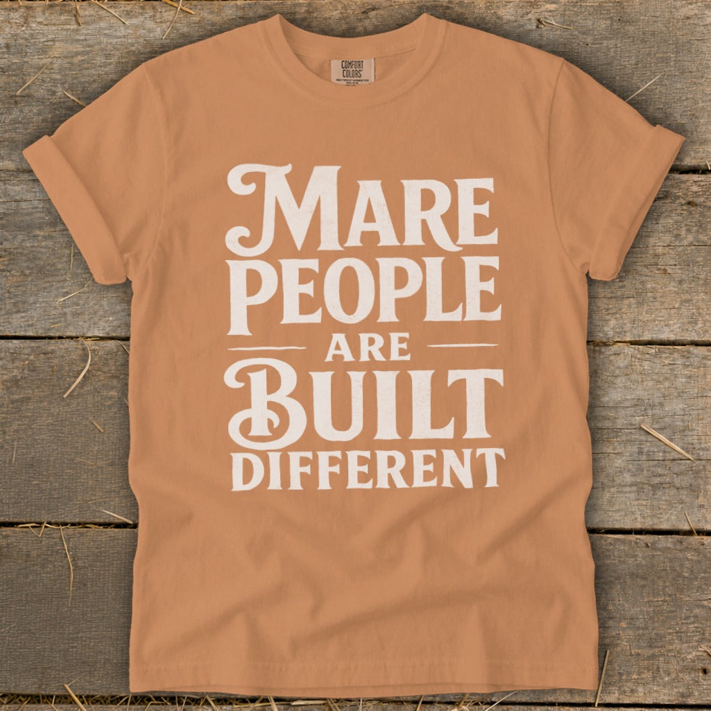 Orange t-shirt with white text that reads "Mare people are built different".