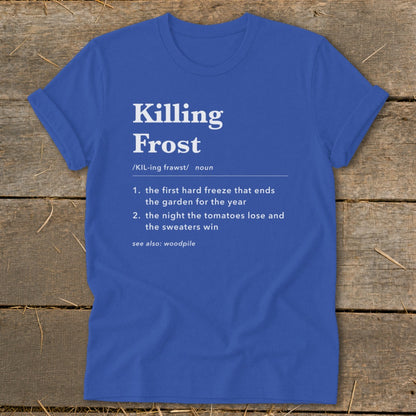 Blue t-shirt featuring dictionary-style text with the definition of Killing Frost laid out on a rustic wooden background.