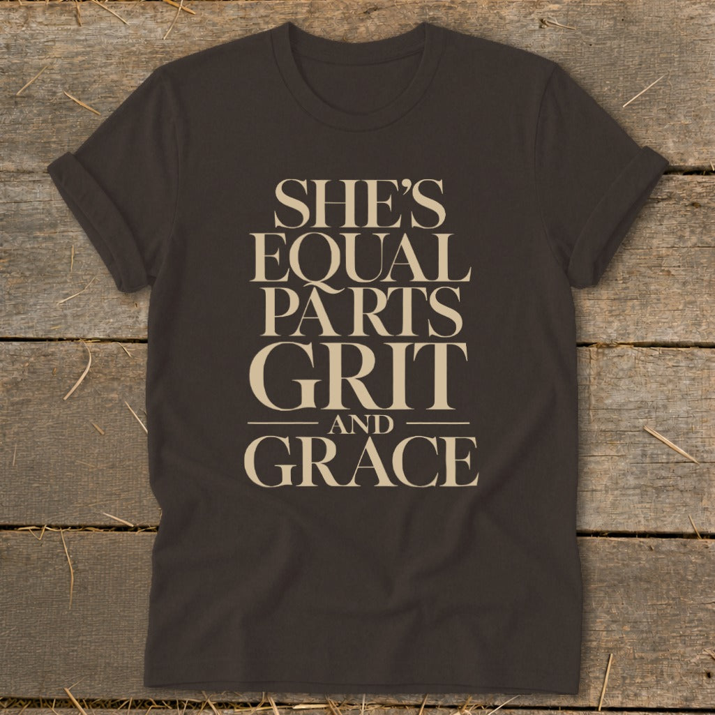 Dark brown t-shirt with "She's Equal Parts Grit and Grace" printed in beige.