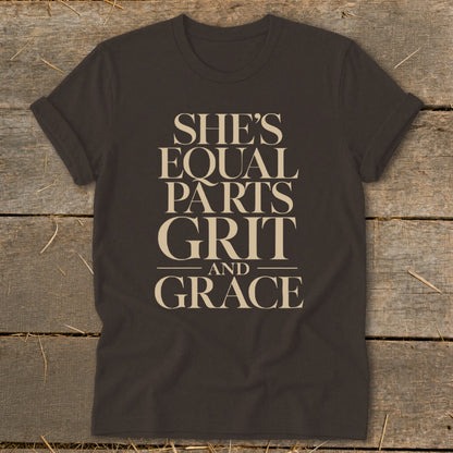 Dark brown t-shirt with "She's Equal Parts Grit and Grace" printed in beige.
