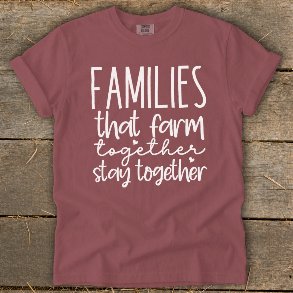 Burgundy t-shirt with white text that reads "FAMILIES that farm together stay together."