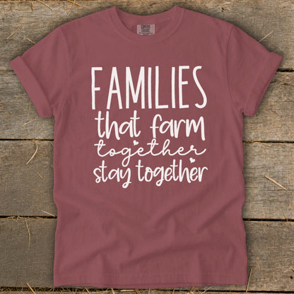 Burgundy t-shirt with white text that reads "FAMILIES that farm together stay together."
