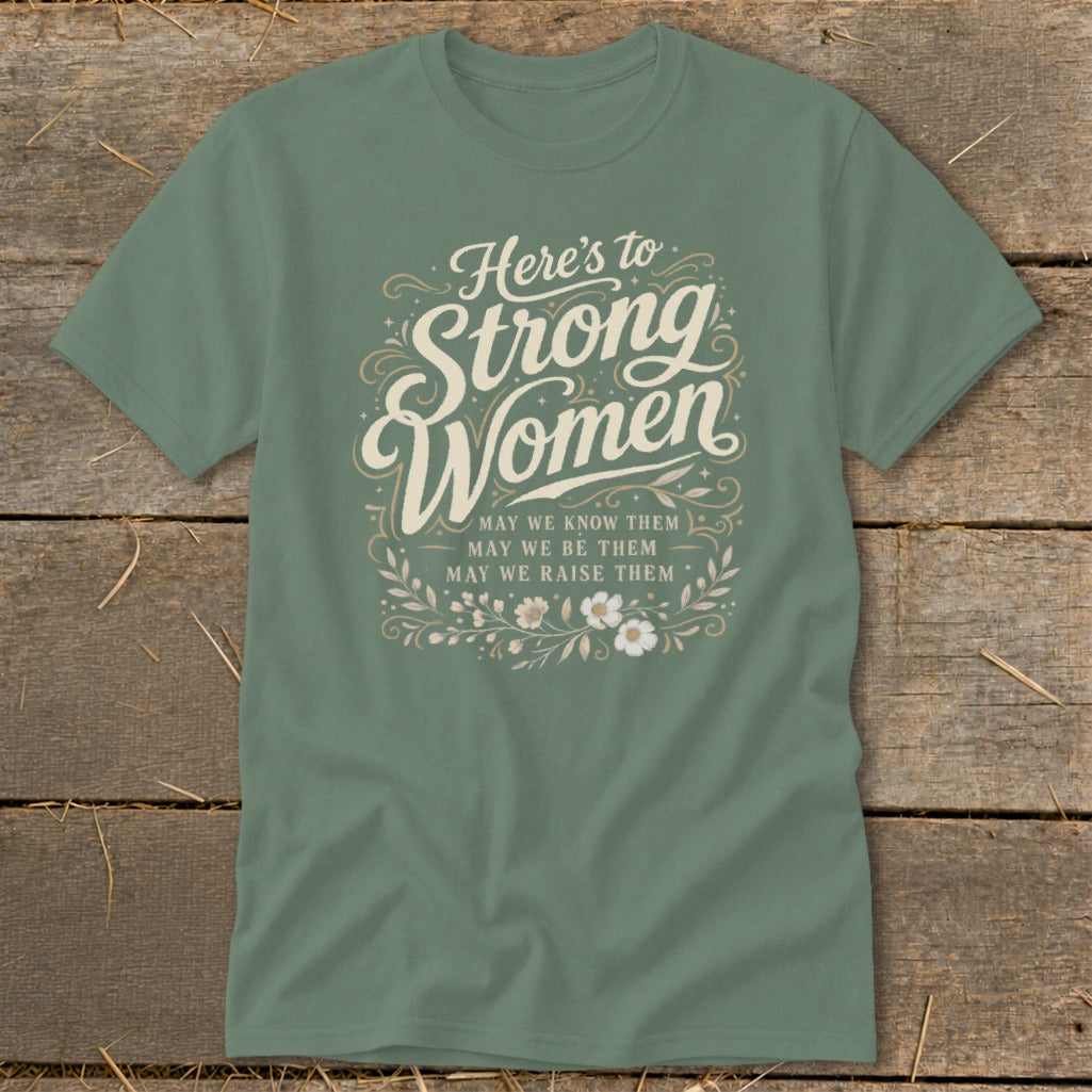 Green t-shirt with "Here's to Strong Women" text and floral accents.