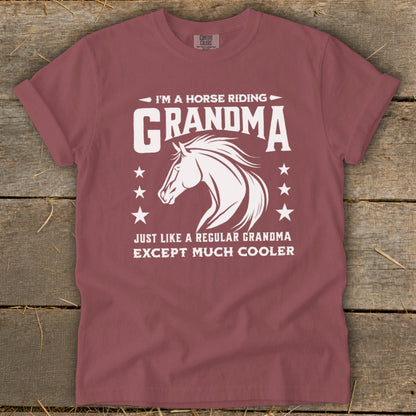 Maroon t-shirt with white text and horse graphic: "I'm a horse riding grandma except much cooler."