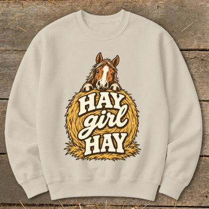 Light beige sweatshirt with horse peeking over hay bale graphic and "Hay girl hay" text.