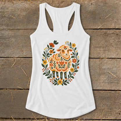 White tank top with a folk art style sheep illustration surrounded by floral elements.