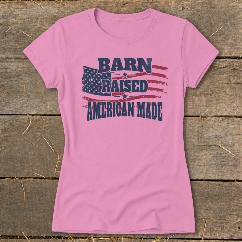 Pink t-shirt with American flag graphic and text "Barn Raised American Made."