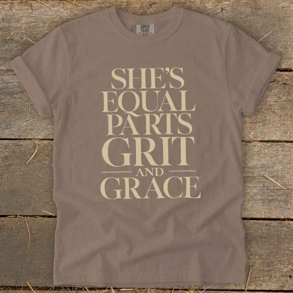 Brown t-shirt with "SHE'S EQUAL PARTS GRIT AND GRACE" text in cream.