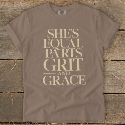 Brown t-shirt with "SHE'S EQUAL PARTS GRIT AND GRACE" text in cream.