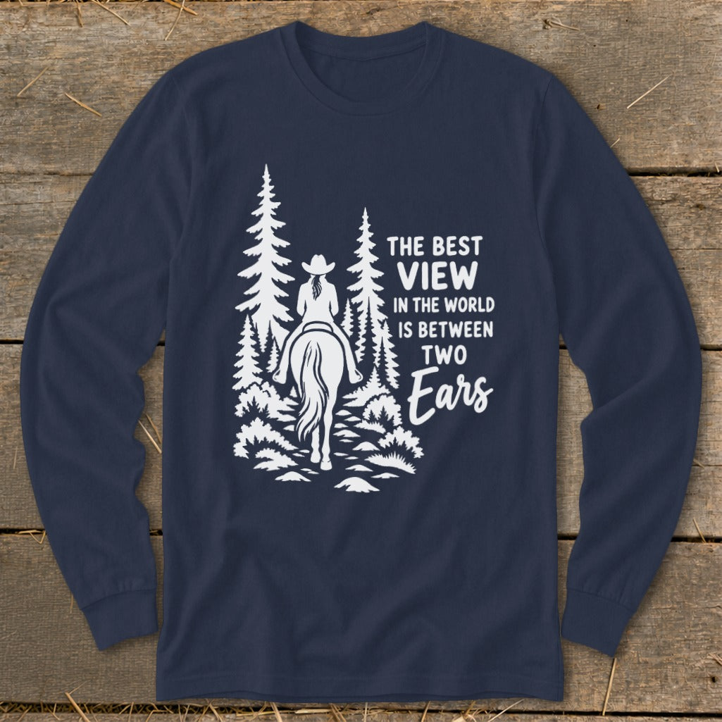 A dark blue long-sleeve t-shirt features a white graphic of a horseback rider in the woods with text reading The best view in the world is between two ears.