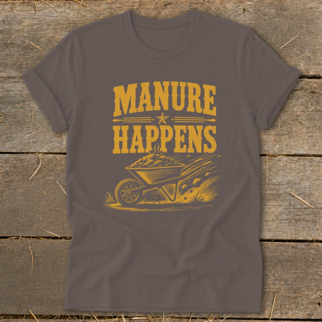 T-shirt with yellow text "Manure Happens" above a wheelbarrow and scattered manure.