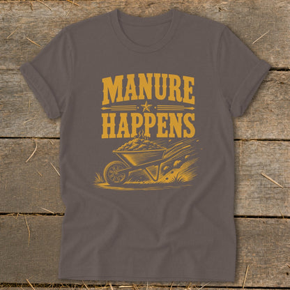 T-shirt with yellow text "Manure Happens" above a wheelbarrow and scattered manure.