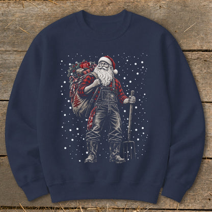 Santa Claus in overalls carrying a sack of gifts and holding a pitchfork.