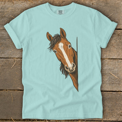 Light blue t-shirt with a drawing of a brown horse peeking from the side.