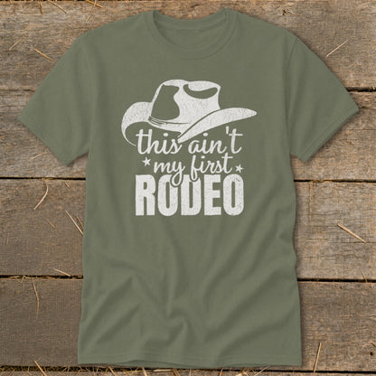 Olive green t-shirt with white distressed graphic of a cowboy hat and text.