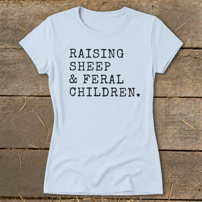 Light blue t-shirt with black text "RAISING SHEEP & FERAL CHILDREN."