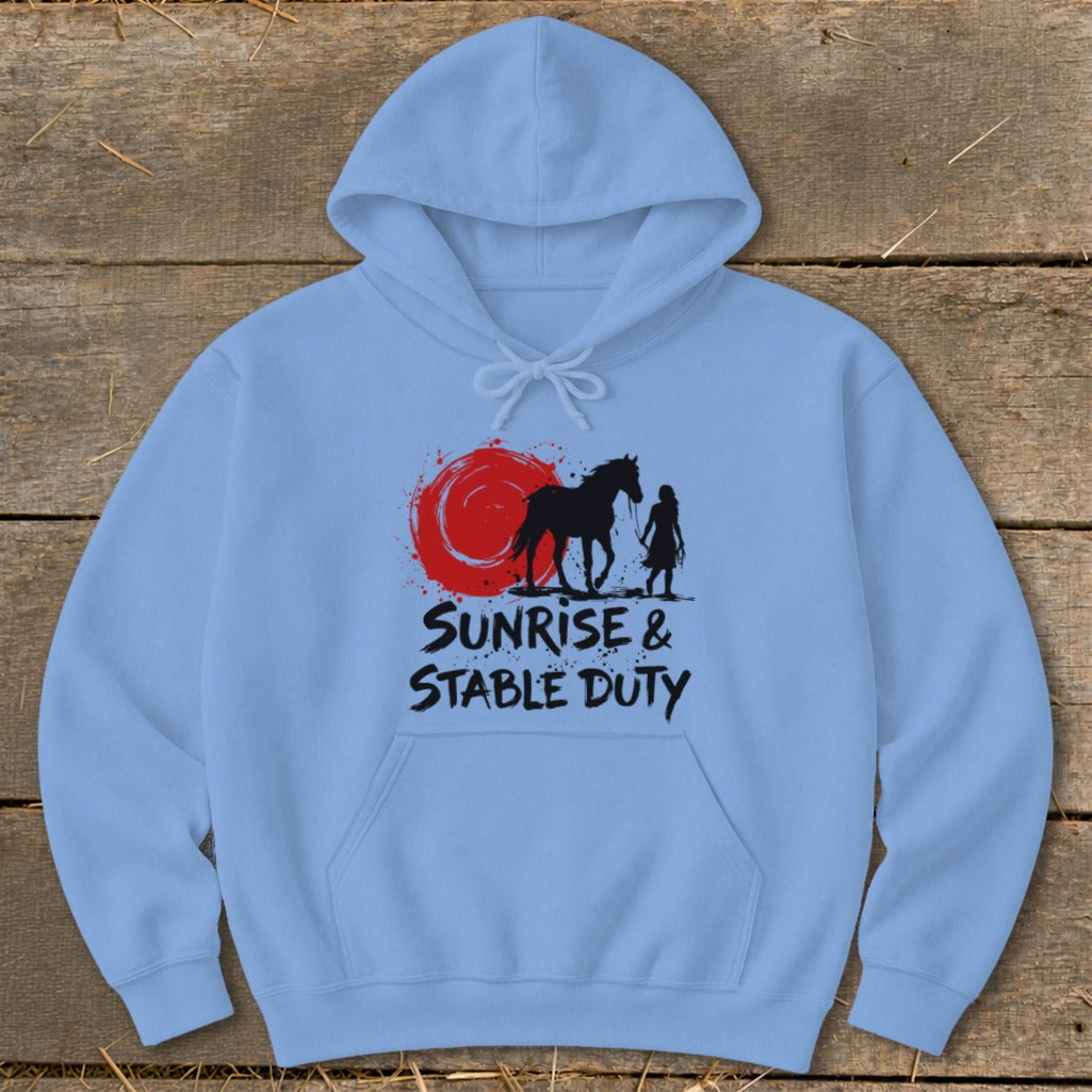Light blue hoodie with black graphic of horse, person, and red sun, text "Sunrise & Stable Duty".